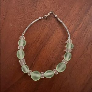 Green sea glass beaded bracelet with silver accents.